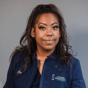 Orthodontic Front Desk member, Joenelle, smiling in her blue Markovitz Orthodontics shirt