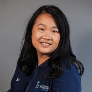 Experienced Orthodontic front desk specialist Joi smiling in her Markovitz uniform.