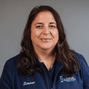Experienced Orthodontic Assistant, Simone, smiling in her blue Markovitz Orthodontics shirt