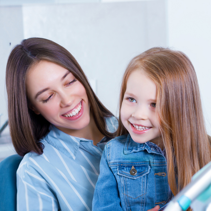 other with her daughter in her lap at her daughter’s orthodontics appointment